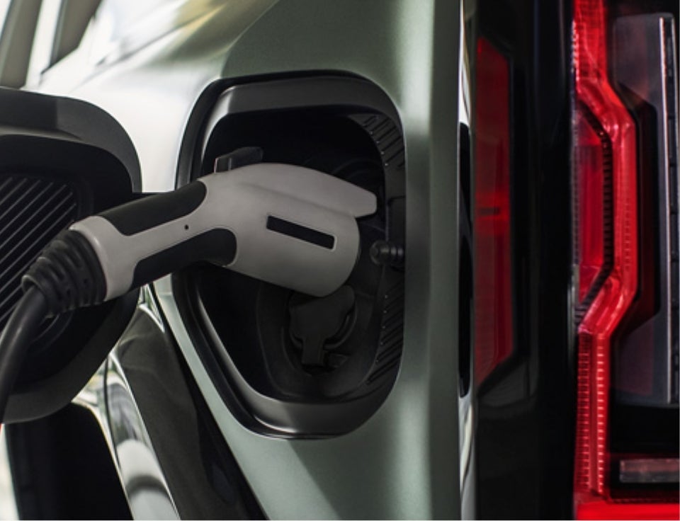 Close up of charging port with charger plugged in on a GMC Hummer EV SUV - North Bay GMC in GREAT NECK NY