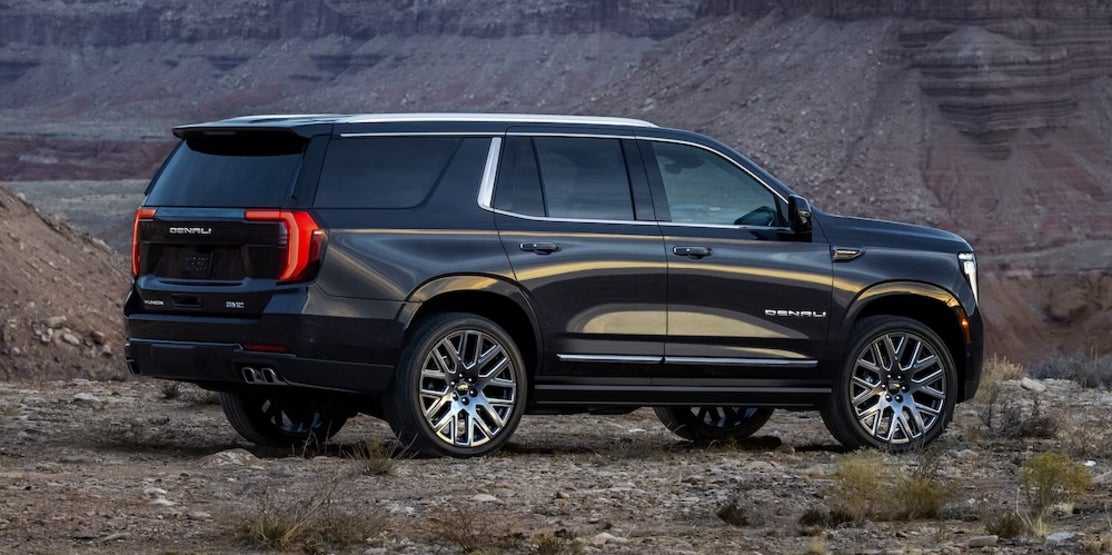 A side view of a black 2026 GMC Yukon SUV